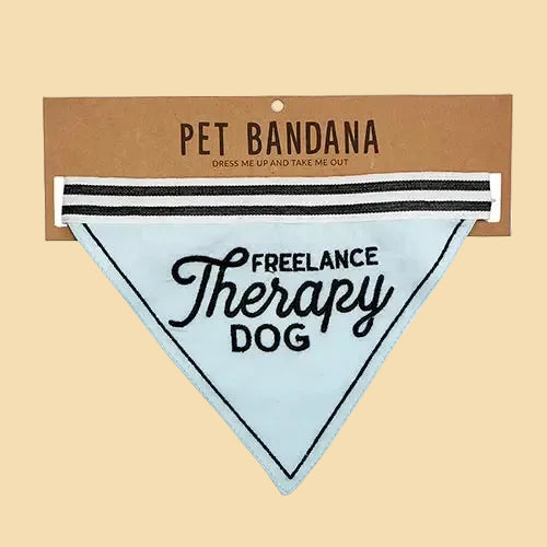 Pet bandana with 'Freelance Therapy Dog' text on a cardboard backing
