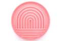 A round pink silicone plate with concentric rainbow arches and horizontal ridges, shown from a top-down view on a white background.